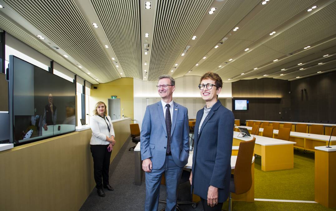 Chief Justice, Helen Murrell shows attorney general, Gordon Ramsay around the new court room's advanced technology. Pictured with in court technology officer, Drani Sarkozi. Photo: Elesa Kurtz