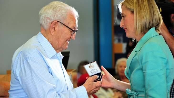 Chief Minister Katy Gallagher presents Leonard Praks with a Centenary medallion in January. Photo: Karleen Minney