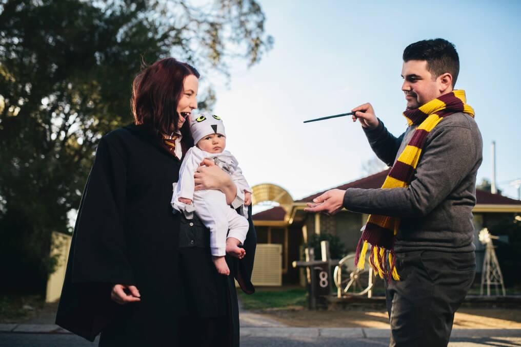 Cosplay couple Bec and Andrew Grayson as Gryffindor students, with baby daughter Aurora as Hedwig. Photo: Rohan Thomson