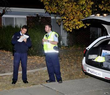 ACT Police bomb response team members investigate a suspicious package at Tewksbury Circuit, Theodore, Canberra. Photo: Melissa Adams
