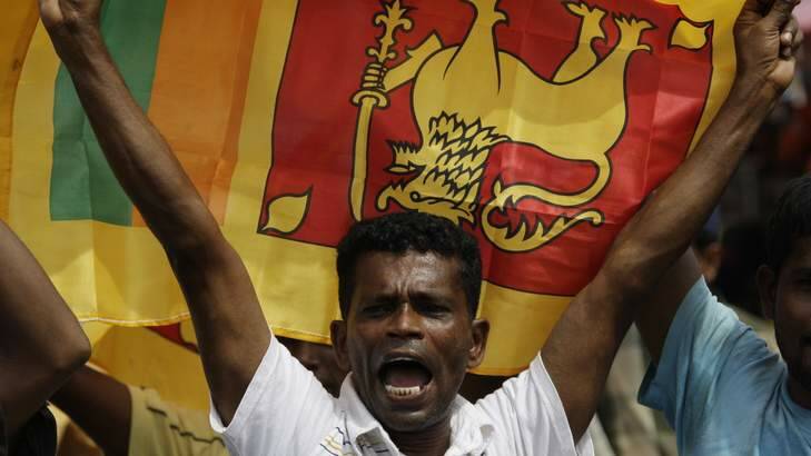 A Sri Lankan man waves his national flag in central Colombo. Photo: David Gray