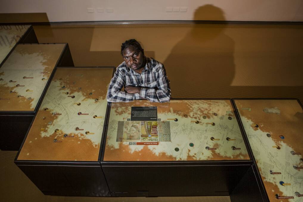 Artist/film maker Curtis Taylor, with 'touch tables' containing his film in the new exhibition, Kaninjaku: Stories from the Canning Stock Route at the National Museum of Australia.  Photo: Jamila Toderas