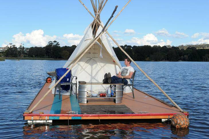 William Woodbridge maintains his teepee raft protest  on Lake Ginninderra. He is angry about housing affordability for students in Canberra. Photo: Gary Schafer GCS