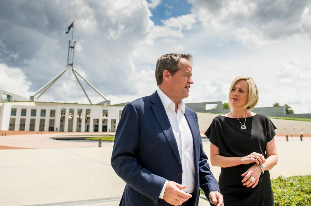 Opposition leader Bill Shorten and ACT Chief Minister Katy Gallagher take a walk around Parliament house after Ms Gallagher announced her departure.  Photo: Jay Cronan