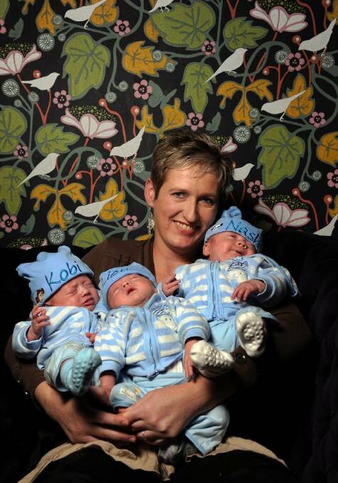 Karen Guthrie with her identical boy triplets (L to R) Kobi, Liam and Nash at a Bite to Eat cafe in the Chifley Shops. Photo: Colleen Petch