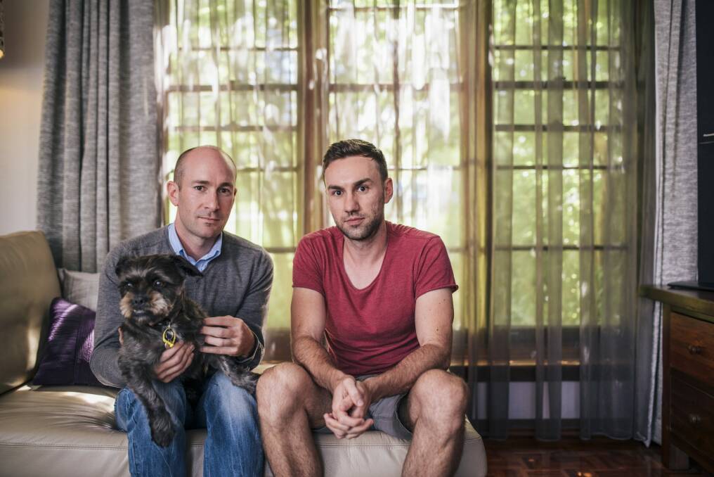 Ben O'Bryan and Michael Romei, with dog Lulu, at their duplex home in Yarralumla. Photo: Rohan Thomson