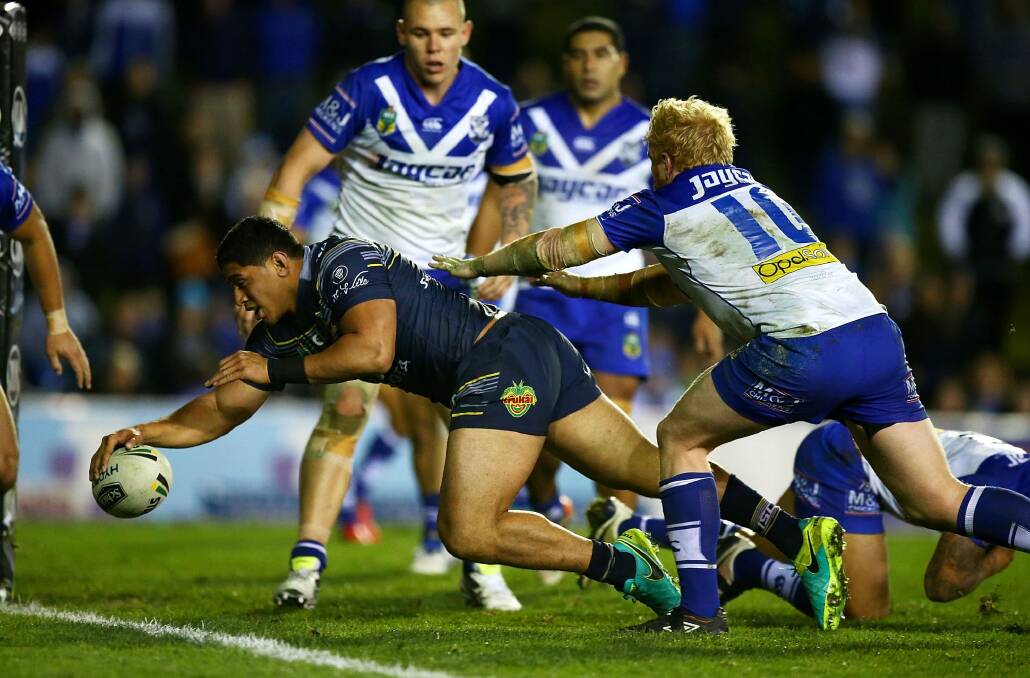 Unstoppable: Jason Taumalolo stretches to touch down for a try. Photo: Mark Nolan