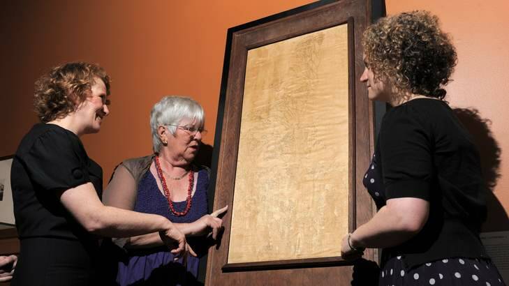 Victoria Gill, Marie Nicholls and Alexa McNaught-Reynolds with the restored lithograph by Marion Griffin. Photo: Graham Tidy