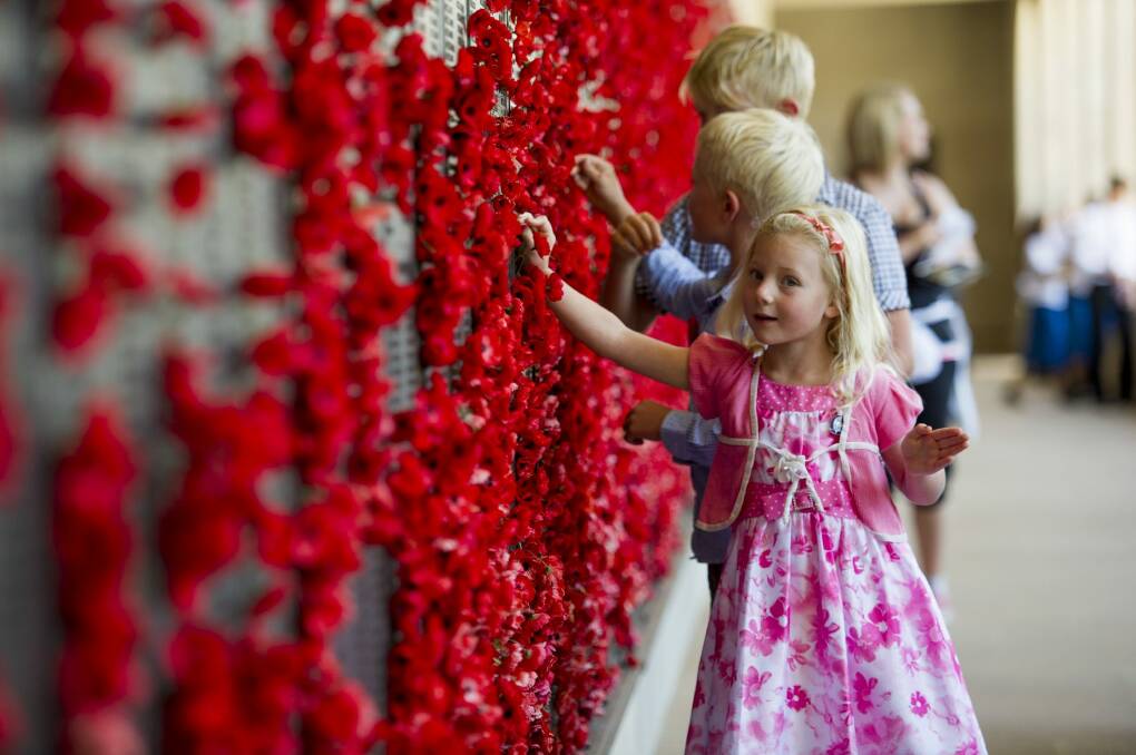 Sydney siblings Amelia, 5, Tristan, 7, and Jack Clapham, 9,  at the Australian War Memorial for Remembrance Day. Photo: Jay Cronan
