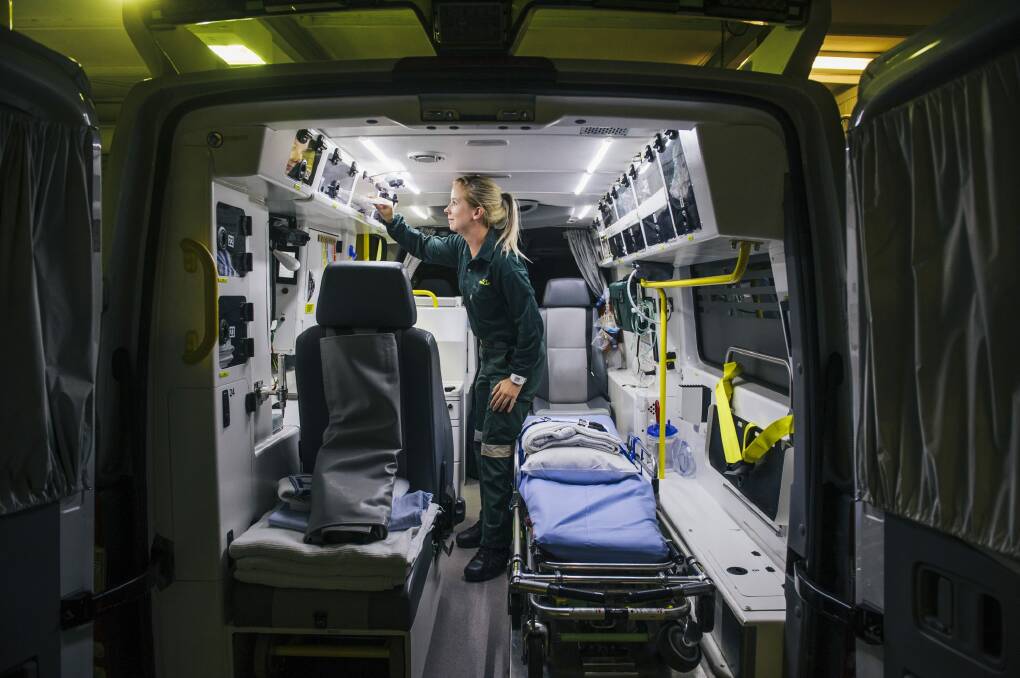 Paramedic Jess Wilson restocks the ambulance after a job. Photo: Rohan Thomson