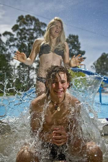 Canberra High year 10 students Jeremy Bradbury and Triska Hoelzl  escape the heat at the Big Splash water park with water filled balloons last month. Photo: Jay Cronan