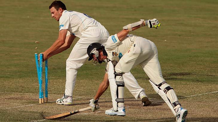 Josh Hazlewood of the Blues unsuccessfully attempts to run out Michael Hogan of the Warriors. Photo: Getty Images