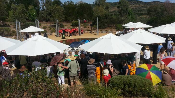 Everyone crowds into the shade at the official commemoration of the 2003 bush fires.