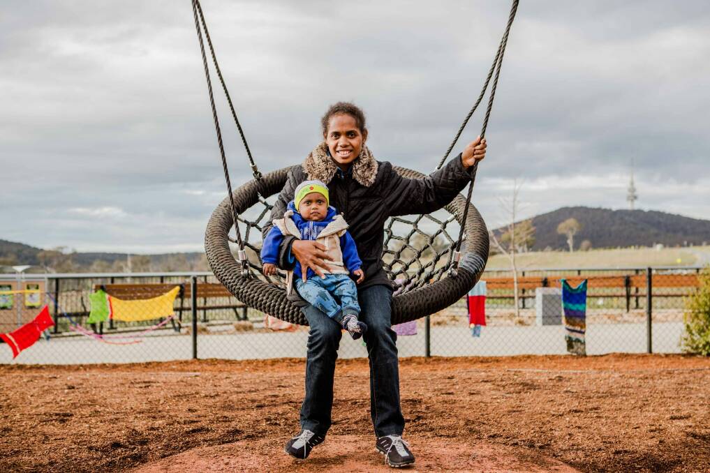 Charlie and his mother Mary Ribe enjoy a swing at the National Arboretum. Photo: Jamila Toderas