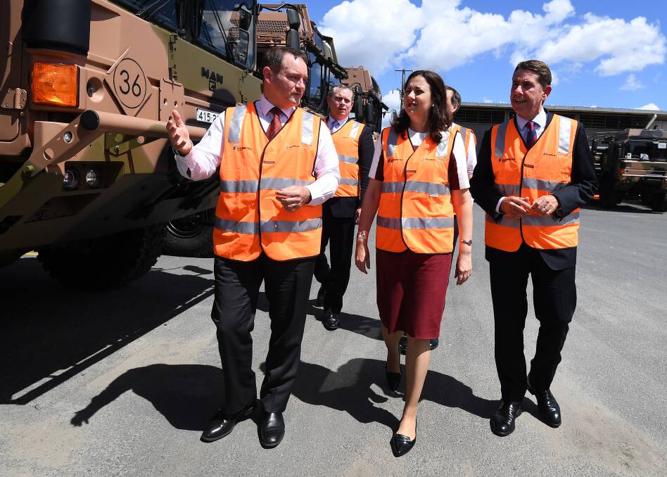 Queensland Premier Annastacia Palaszczuk (centre) and Minister for State Development Cameron Dick (right) are given a tour by Rheinmetall Defence Australia managing director Gary Stewart at the Rheinmetall Man Military Vehicles facility in Brisbane. Photo: AAP