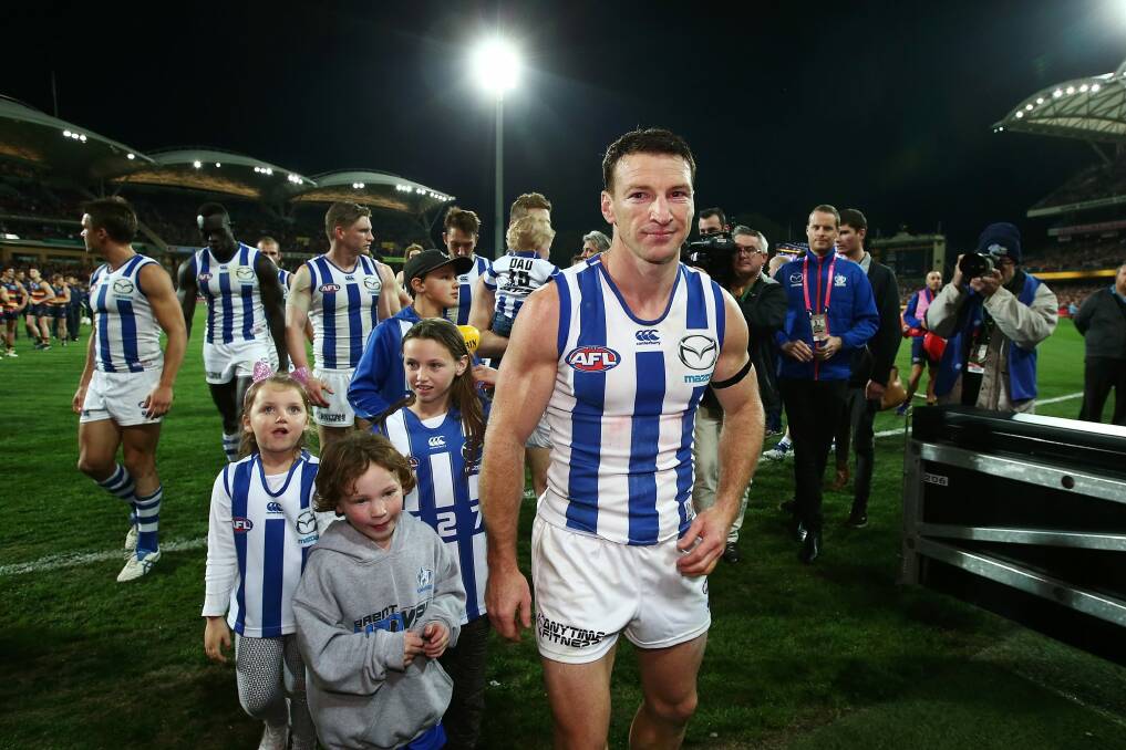 Games-record holder Brent Harvey leaving the field for the last time. Photo: Getty Images