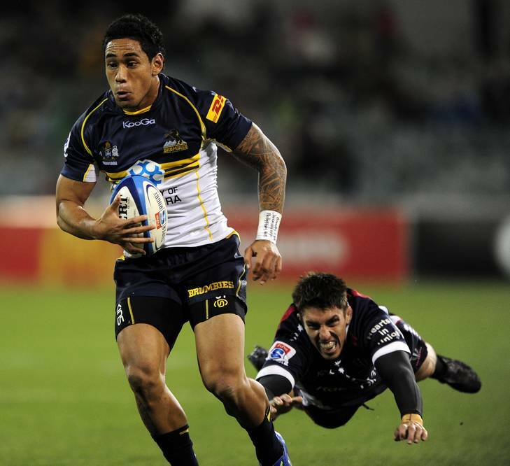 Joe Tomane of the Brumbies leaves Luke Holmes of the Rebels in his wake during the Round 8 clash against the Rebels. Photo: Stuart Walmsley