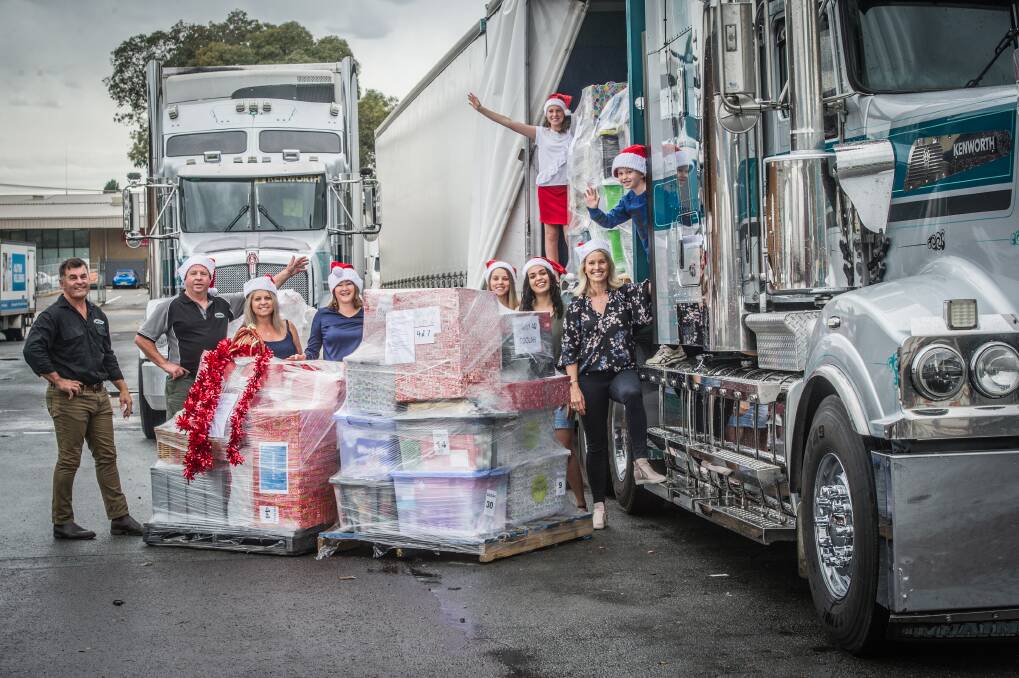 Helpers load the Christmas packages for transport from  Canberra to regional NSW. Photo: Karleen Minney