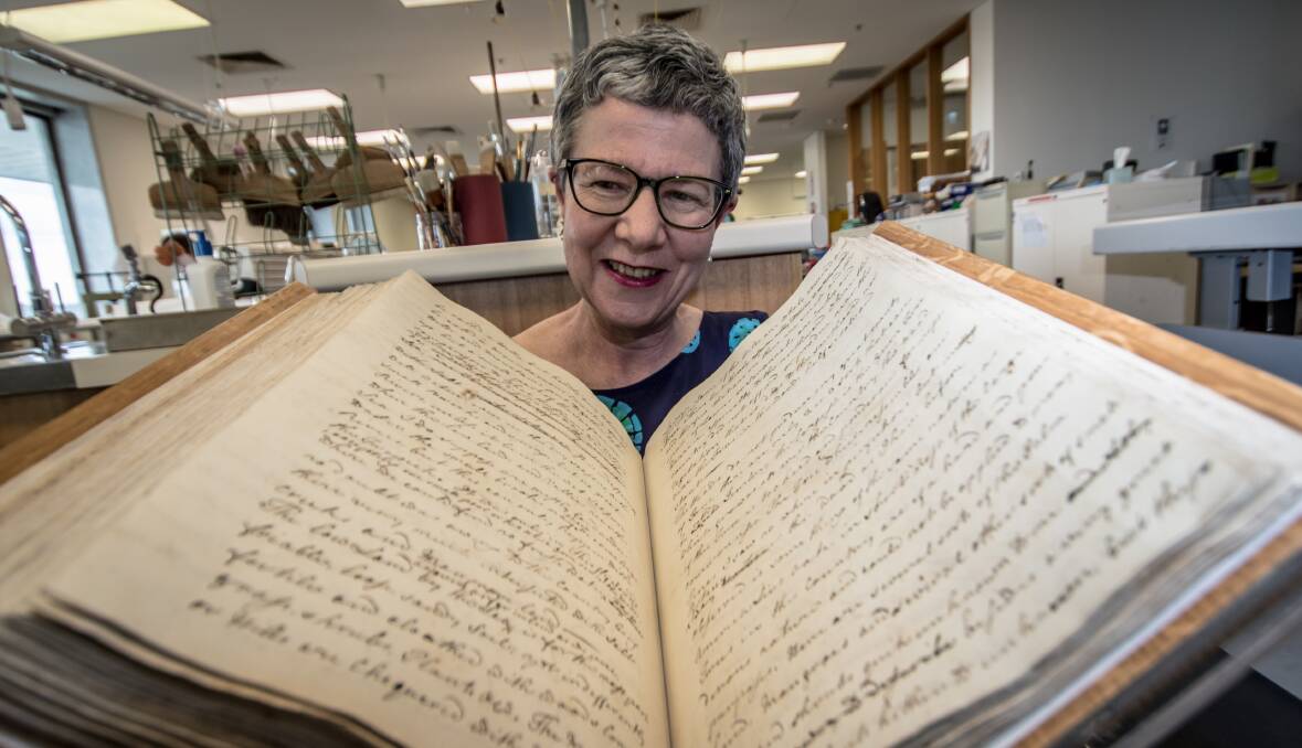 Pictured with the 250 year old captain's log from the Endeavour sailing, National Library of Australia director general Dr Marie-Louise Ayres announce the upcoming major international exhibition, Cook and the Pacific.  Photo: Karleen Minney