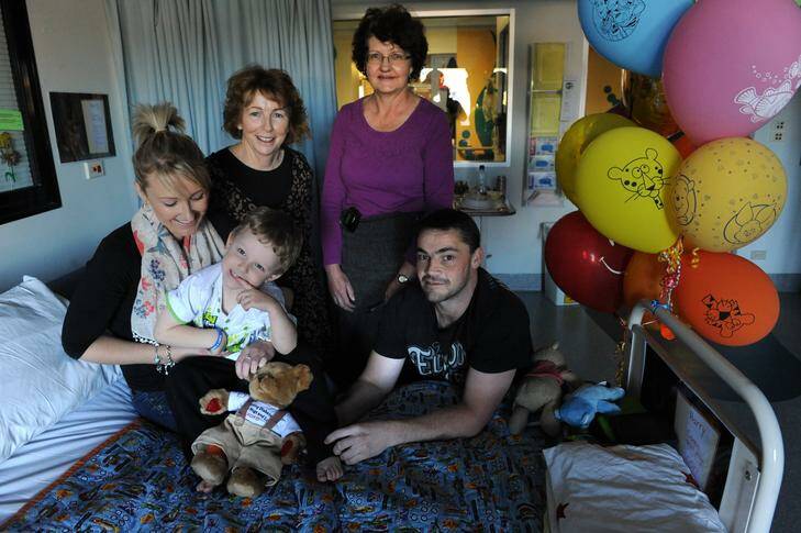 Four year-old Harri Browne, of Queanbeyan, who has been diagnosed with type 1 diabetes, pictured at the Canberra Hospital with his parents Jamie and Mel Browne, diabetes educator Michelle Angrove, second from left, and diabetes clinical nurse consultant Di Roberts, standing. Photo: Richard Briggs