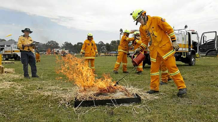 Gungahlin Rural Fire Service member Ed Wilkinson using a drip torch as part of a demonstration at the Emergency Services Facility in Hume. Photo: Jeffrey Chan 