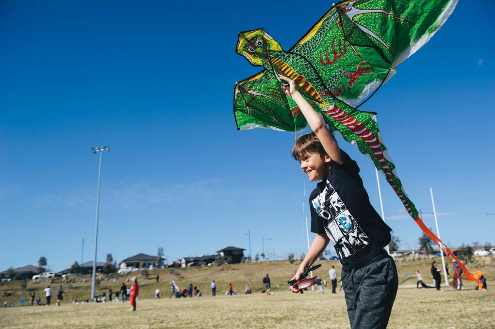 Macca Cleary, 9, of Queanbyean trying to get his kite up despite a lack of wind at Flying High in the Googong Sky on Sunday morning. Photo: Rohan Thomson