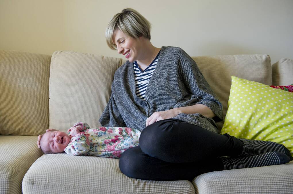 <i>The Voice's</i> Amber Nichols at home in Canberra with her new baby daughter Olive. Photo: Jay Cronan