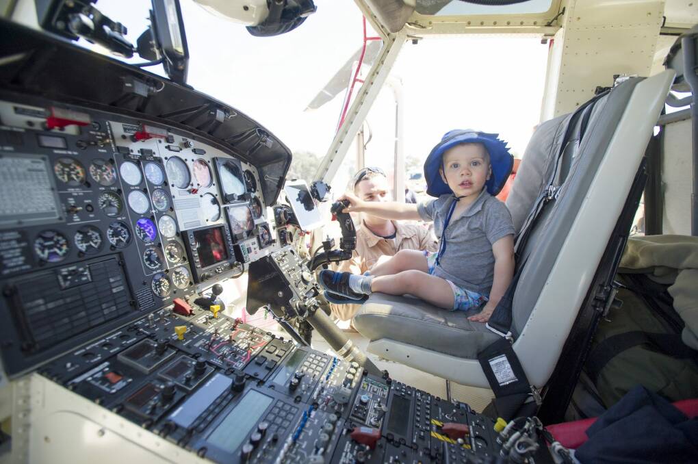 Cooper Pitts, 2, checks out the helicopter controls at the Rural Fire Service open day. Photo: Jay Cronan