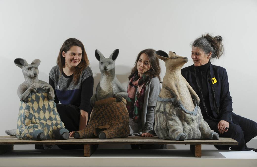 Australian Ceramics Triennale project managers Yasmin Masri (left) and Gwenyth Macnamara with chairwoman Avi Amesbury, pictured with Bev Hogg’s work <i>Wooly Jumpers 1</i>, <i>2</i> and <i>3</i>, which feature in Craft ACT’s exhibition Stomping Ground, in the ACT Legislative Assembly gallery.  Photo: Graham Tidy