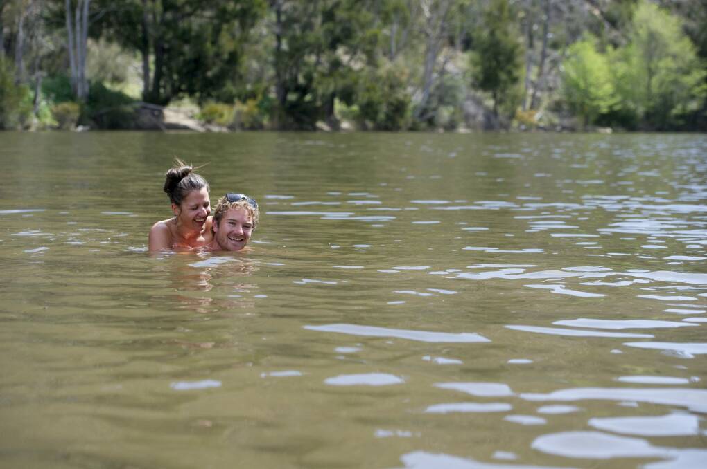 James Foster and Sharnel Chatworthy cool off in the cold water of at the Kambah Pools. Photo: Jay Cronan