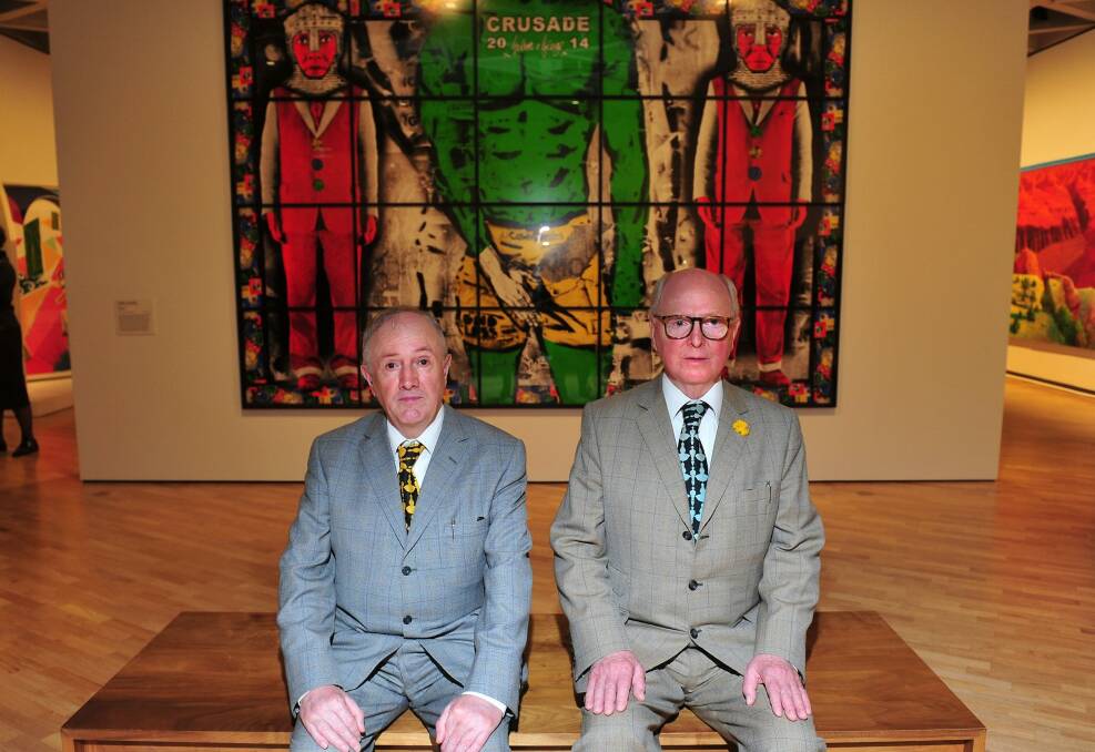 Gilbert and George in front of their work at the National Gallery of Australia. Photo: Melissa Adams