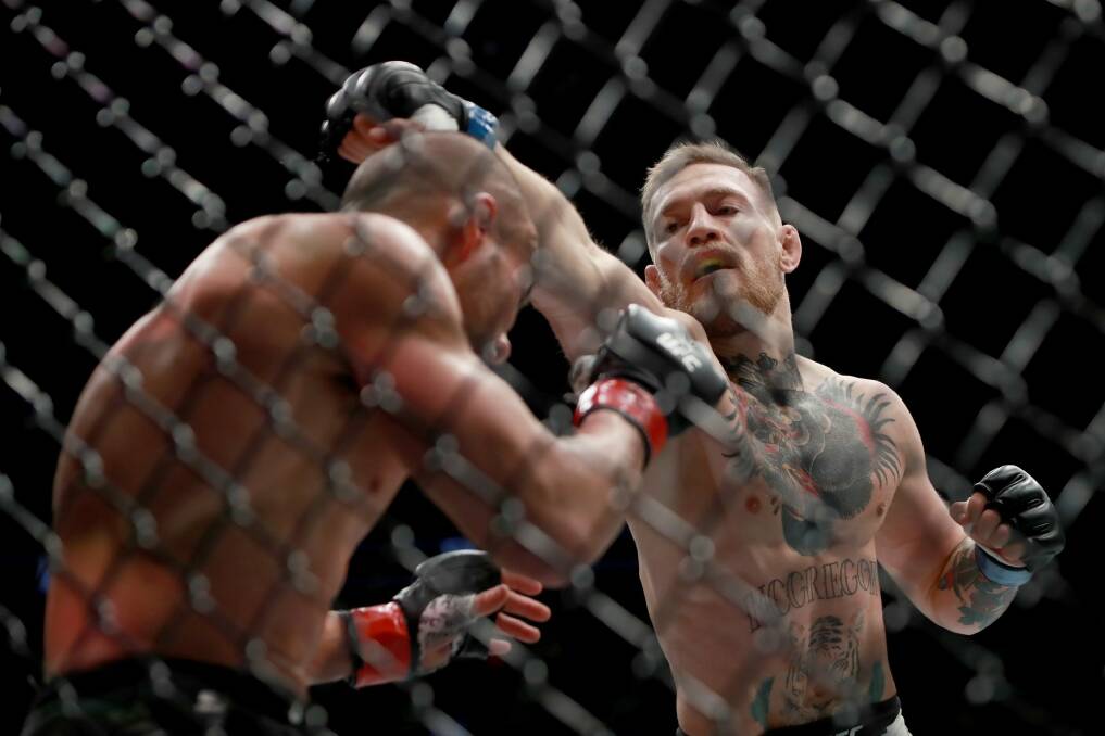 Conor McGregor punches Eddie Alvarez in their UFC lightweight championship fight last November. Photo: Getty Images