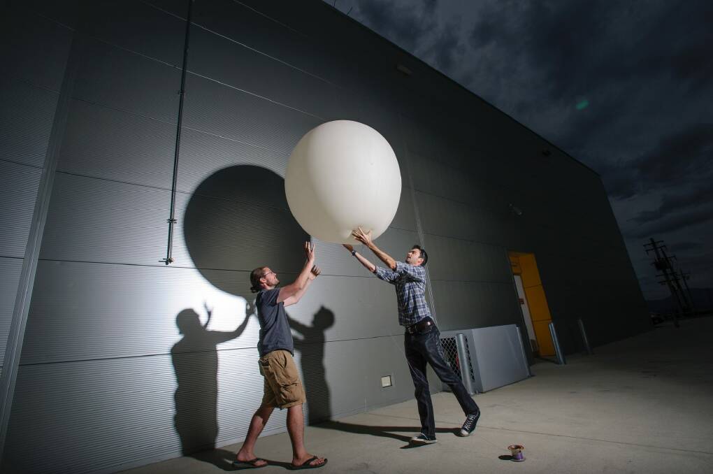 ANU astronomer Dr Brad Tucker and engineer Dr James Gilbert with one of their high altitude balloons.  Photo: Sitthixay Ditthavong