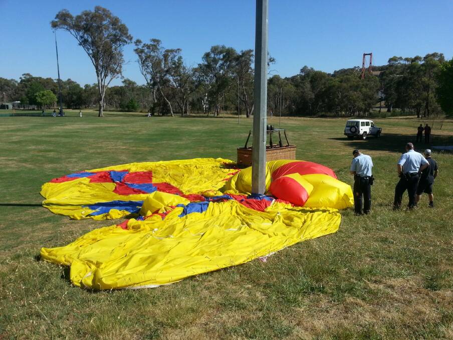 A hot air balloon which became tangled with a light pole in Aranda while landing. Photo: Ben Westcott