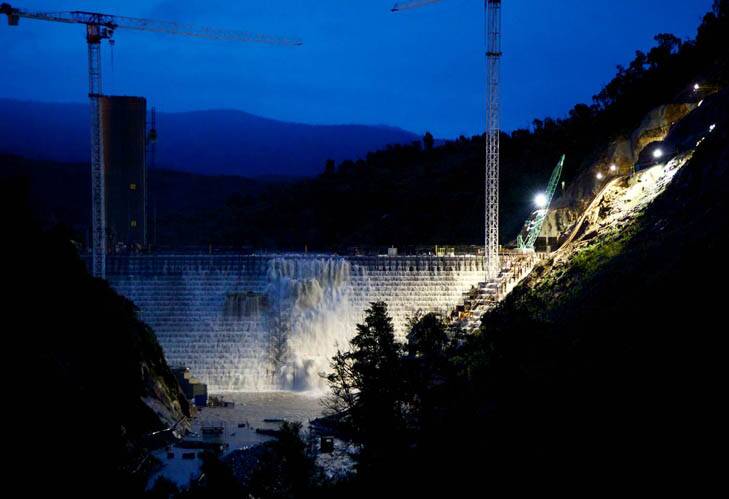 Dam full ... water flowed freely over the new Cotter Dam last night. Photo: David Fintan