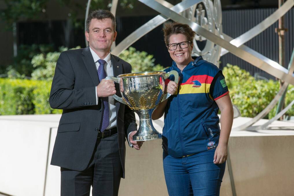 AFP commissioner, Andrew Colvin welcomes Women's AFL premiership coach and AFP officer Bec Goddard back to Canberra. Photo: Supplied