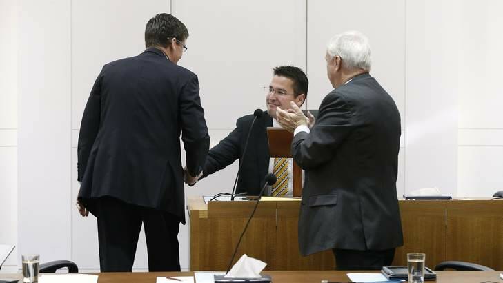 Zed Seselja, centre, is congratulated by his Liberal colleague following his farewell speech. Photo: Jeffrey Chan