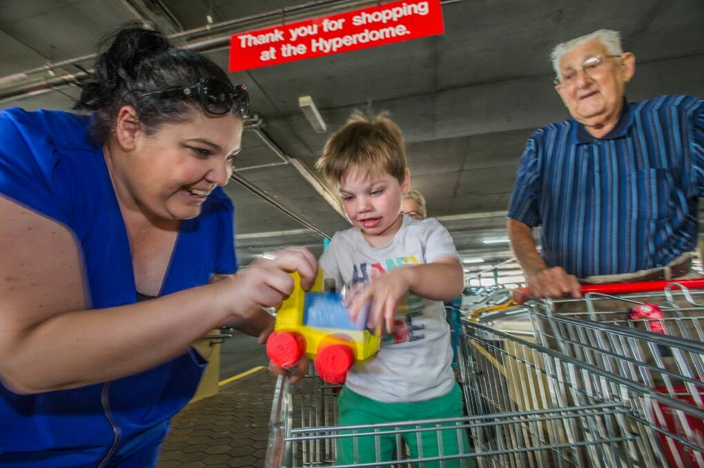 Rebecca Dawson of Holder with her son Oliver, 2, who scored a wooden train at the Tuggeranong Hyperdome. People are calling Mr Fillery Canberra's "real Santa Claus''. Photo: Karleen Minney