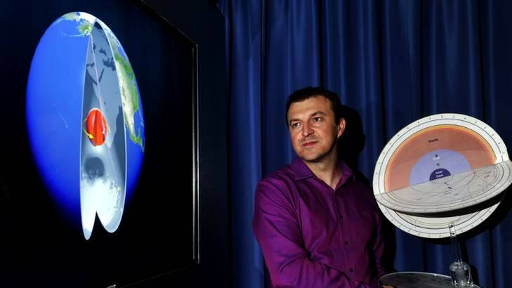 More like rocket science ... Associate Professor Hrvoje Tkalcic with an image of the Earth's inner core rotation and a model of the Earth with seismic waves. Photo: Melissa Adams