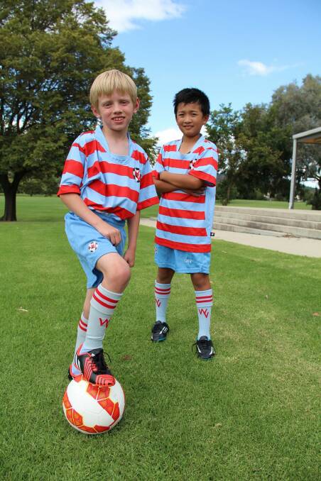 Yuryo Nakamura, 9, and Tommy Golack, 8, are part of Woden Valley Football Club, which has the ACT's biggest contingent of juniors. Photo: Mark Sawa
