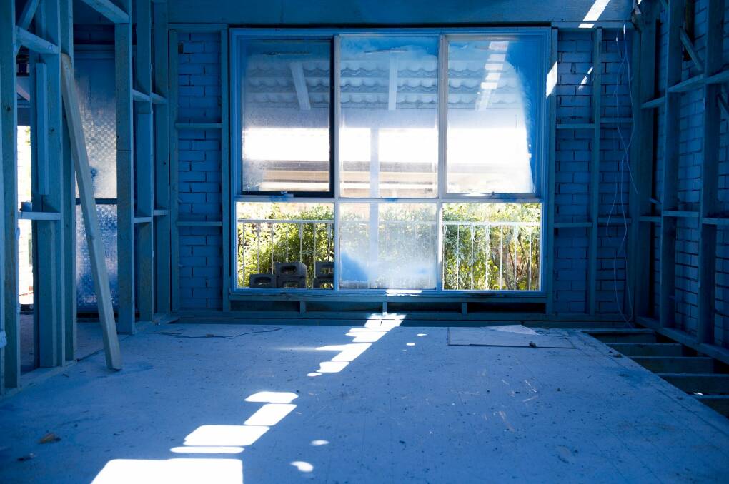 Inside  a Mr Fluffy house in Scullin prior to demolition. The blue paint is from a PVA/paint mixture that minimises the possibility of airborne asbestos.
 Photo: Jay Cronan