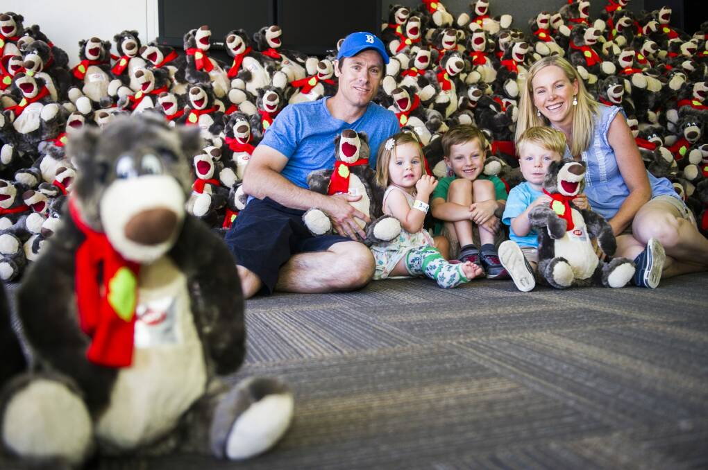 The Davidson family, Brad, Zara (2), Cooper (5), Finn (2) and Megan of Harrison with some of the teddy bears to be given to children at the Canberra Special Children's Christmas Party at Thoroughbred Park on Sunday.
 Photo: Rohan Thomson