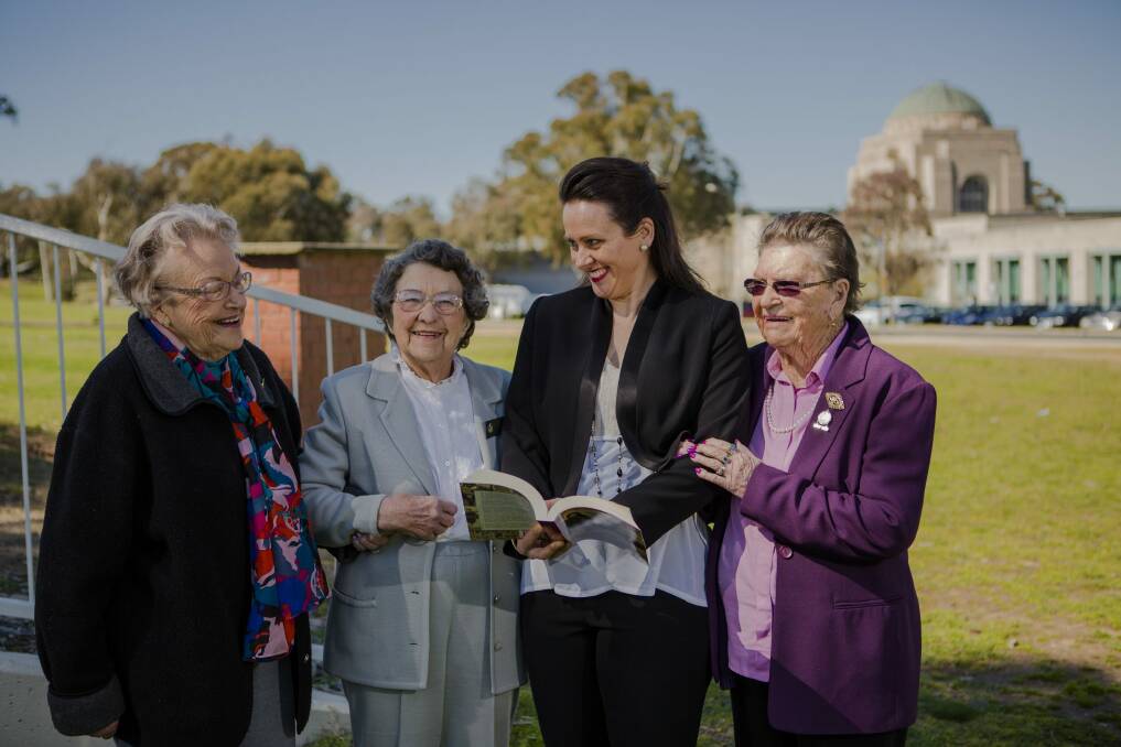 Author Jacqueline Dinan (centre) with her newest book, <i>Between the Dances: World War II Women Tell Their Stories</i>, and with some of the women featured in the book, from left, Thea Commins, Evelyn Booth and Gwen Miles. Photo: Jamila Toderas