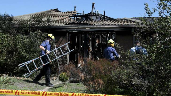 ACT Fire and Rescue members at the scene following a fire in a duplex at Bural Court. Photo: Jeffrey Chan