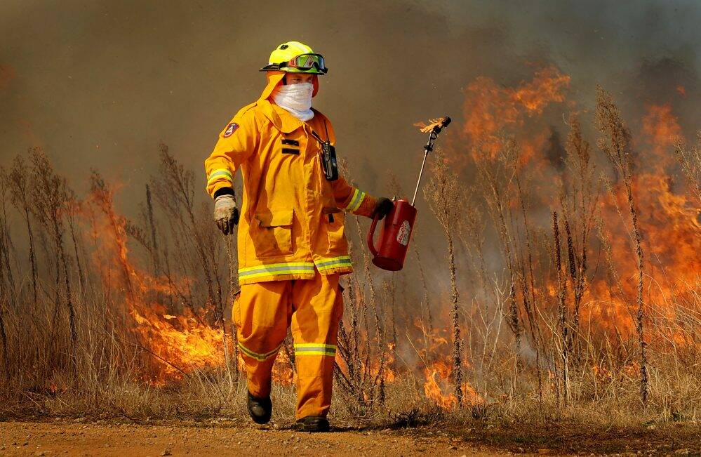 An ACT rural firefighter performs prescribed burning in 2012. Photo: Colleen Petch