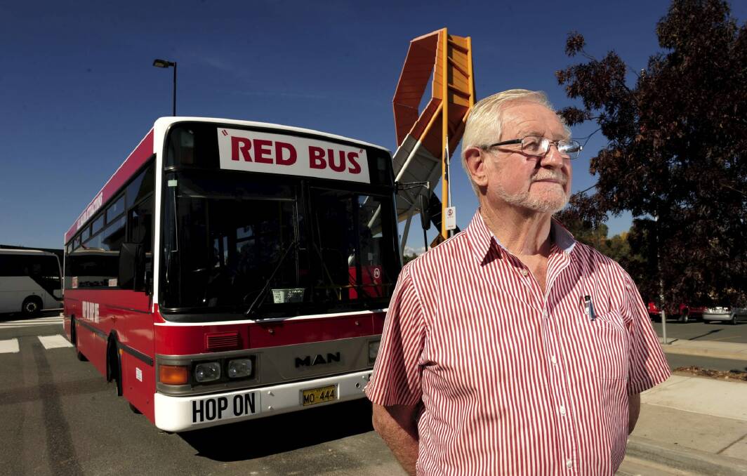 The Red Explorer Bus operator, John Williams, with his bus at the National Museum of Australia. Photo: Graham Tidy