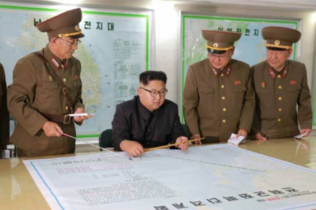 Kim Jong-un consults maps of proposed missile launches to Guam, in this image published by North Korean state media. Photo: KCNA