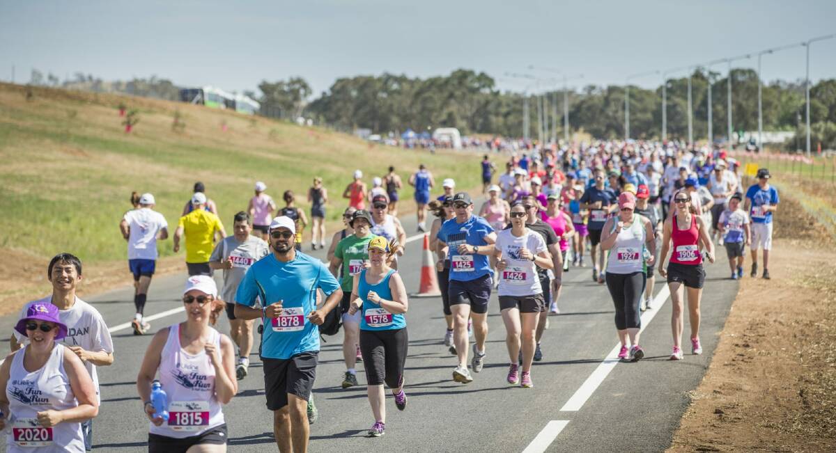 Runners take to the new Majura Parkway at the start of the 5-kilometer event during the Run For Your Lifeline Canberra Fun Run. Photo: Matt Bedford