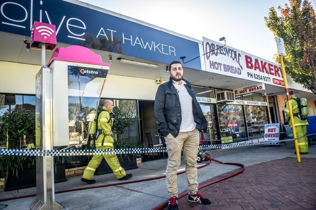 Owner Dimitri Yianoulakis outside Olive at Hawker on Wednesday morning after the restaurant was damaged by fire overnight. Photo: Karleen Minney