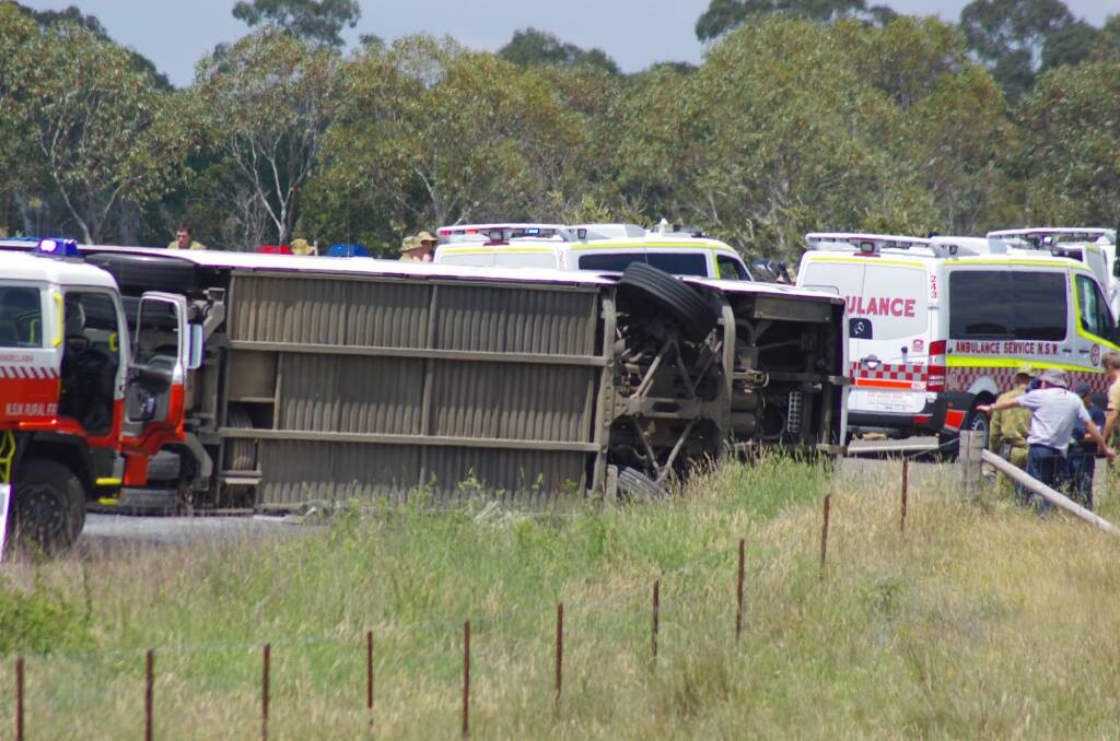 Twelve people have been hospitalised after a bus carrying Australian Defence Force Academy personnel rolled over near Windellama east of Goulburn.  Photo: Darryl Fernance, Goulburn Post.